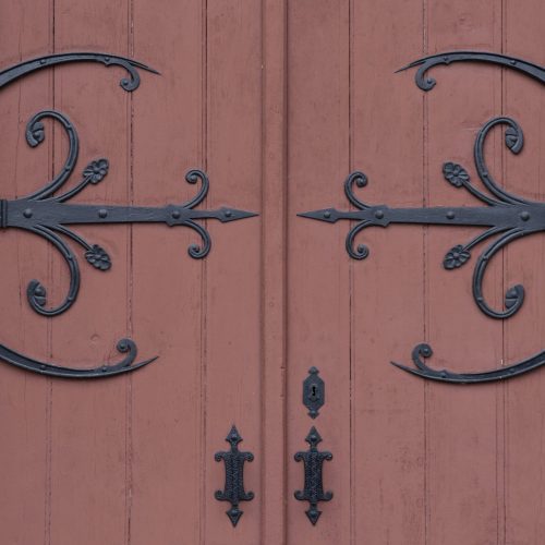 Detail of a wooden and wrought iron door of church in France